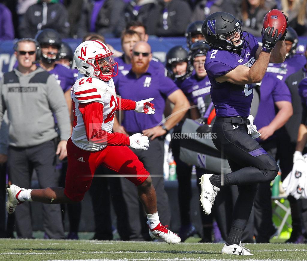 Jim Young Northwestern's Flynn Nagel, right, makes a catch as Nebraska's Aaron Williams looks on during the second half of an NCAA college football game Saturday, Oct. 13, 2018, in Evanston, Ill.. (AP Photo/Jim Young)