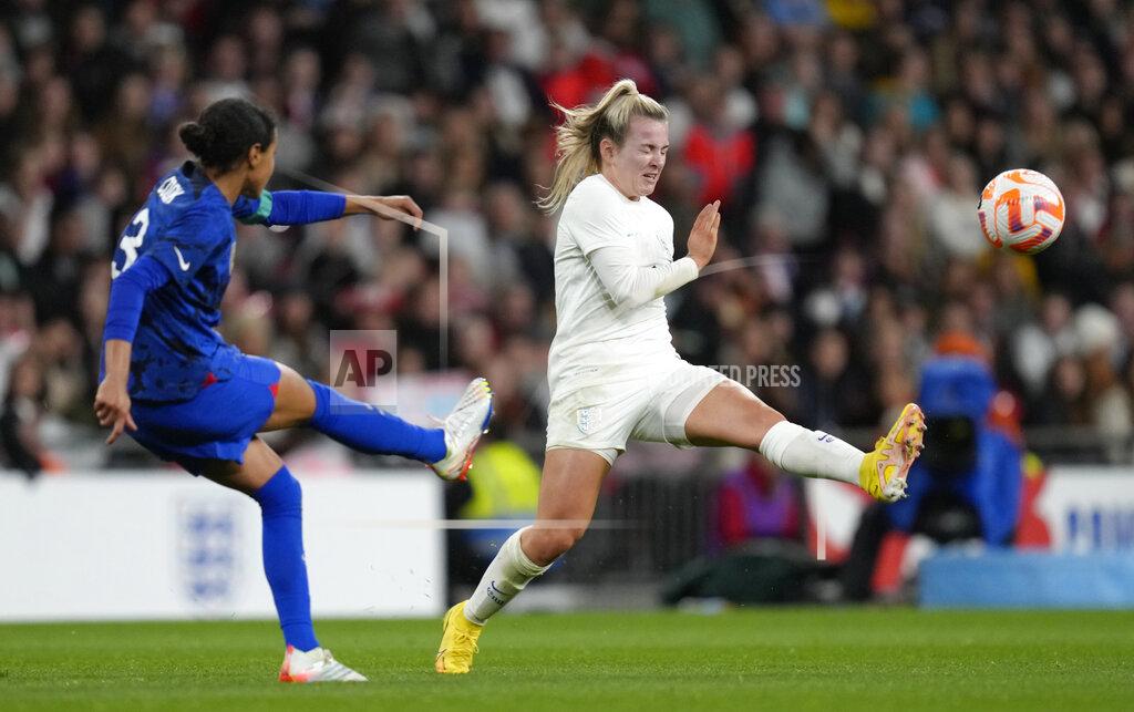 Kirsty Wigglesworth United States' Alana Cook, left, kicks the ball ahead of England's Lauren Hemp during the women's friendly soccer match between England and the US at Wembley stadium in London, Friday, Oct. 7, 2022. (AP Photo/Kirsty Wigglesworth)