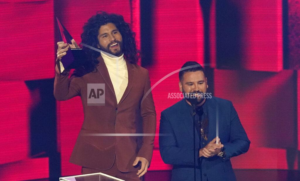 Chris Pizzello Dan Smyers, left, and Shay Mooney, of Dan + Shay, accept the award for favorite country song for "10,000 Hours" at the American Music Awards on Sunday, Nov. 22, 2020, at the Microsoft Theater in Los Angeles. (AP Photo/Chris Pizzello)