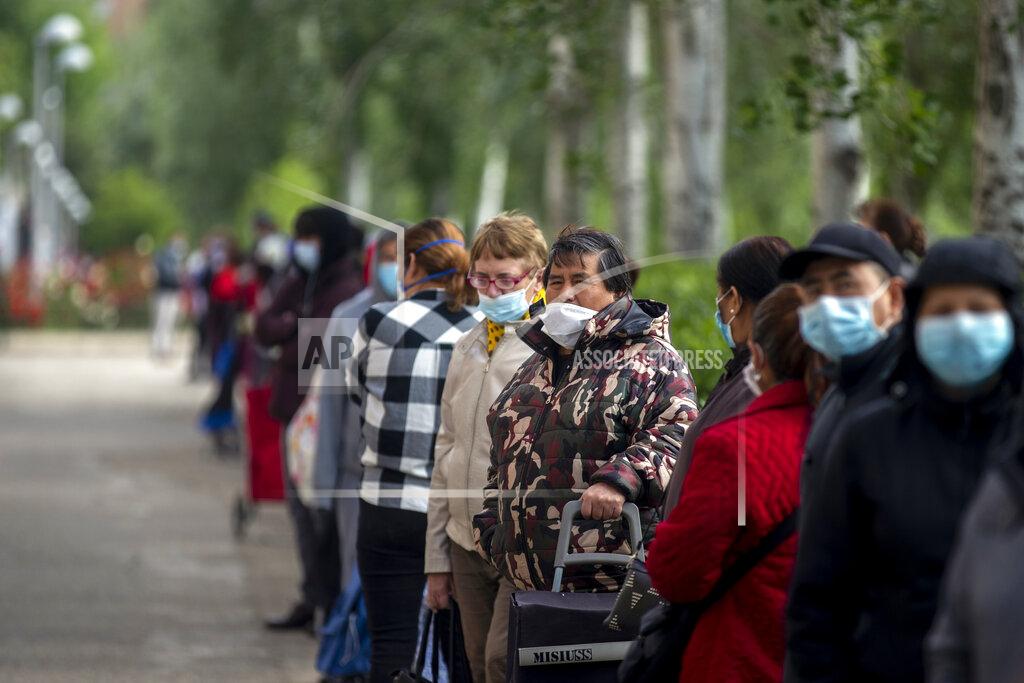 Manu Fernandez People line up as they wait to receive a ration of donated food for people at risk of social exclusion by volunteers from Aluche neighborhood association, in Madrid, Spain, Saturday, May 16, 2020. Aluche Neighborhood association warn that the economic crisis caused by coronavirus has left many out of resources. Spain has been in lockdown to fight the coronavirus pandemic. (AP Photo/Manu Fernandez)