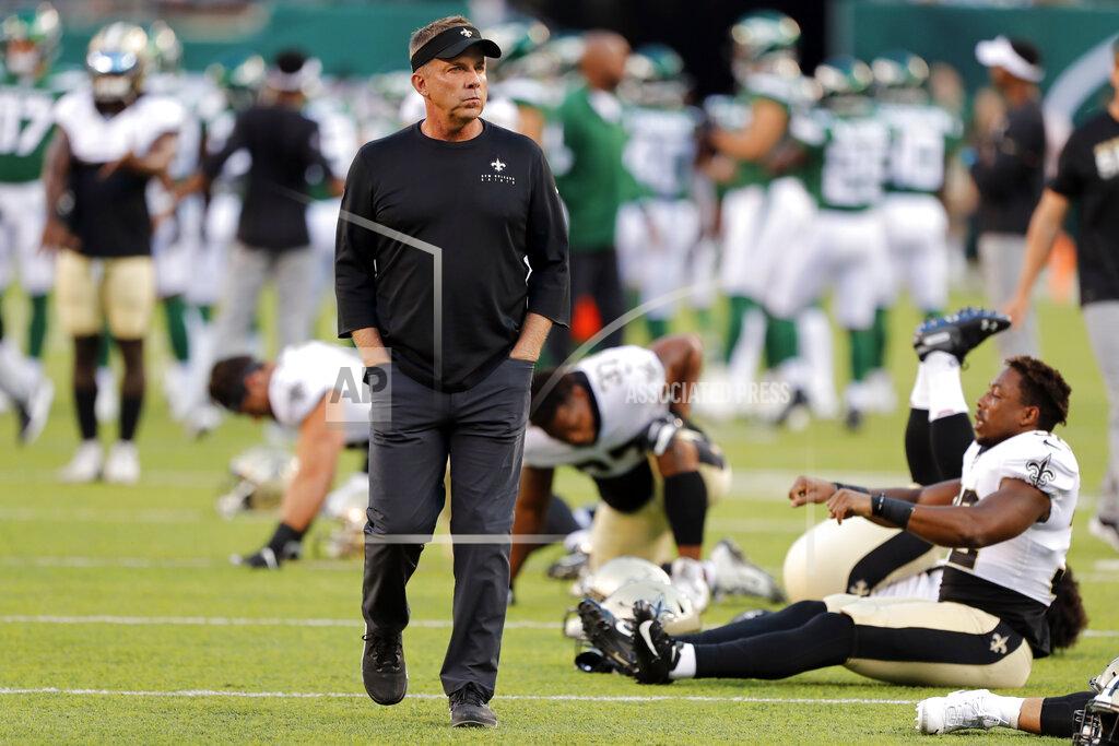 Noah K. Murray FILE - In this Aug. 24, 2019, file photo, New Orleans Saints coach Sean Payton looks at his team as players warm up for a preseason NFL football game against the New York Jets in East Rutherford, N.J. It's the offseason for the NFL, but the need for social distancing and self-isolation by the pro football community was driven home Thursday when New Orleans coach Sean Payton announced he was the first in the NFL to test positive for COVID-19.(AP Photo/Noah K. Murray, File)
