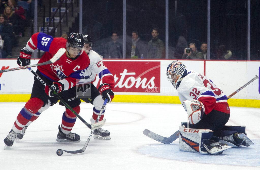 Peter Power FILE - In this Thursday, Jan. 16, 2020, file photo, Team Red center Quinton Byfield (55) moves in on Team White goaltender Dylan Garand (32) while defended by Jack Thompson (23) during the second period of hockey's CHL Top Prospects Game in Hamilton, Ontario. Byfield is one of the top NHL draft prospects. (Peter Power/The Canadian Press via AP, File)