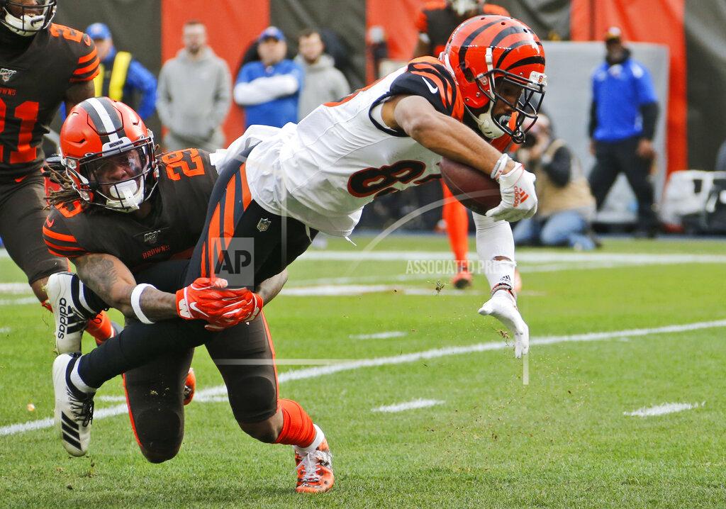Ron Schwane Cincinnati Bengals wide receiver Tyler Boyd (83) dives as Cleveland Browns safety Sheldrick Redwine (29) tackles during the first half of an NFL football game, Sunday, Dec. 8, 2019, in Cleveland. (AP Photo/Ron Schwane)