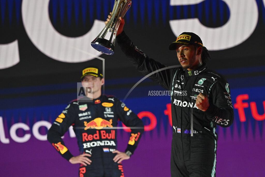 Andrej Isakovic Mercedes driver Lewis Hamilton of Britain celebrates winning the Formula One Saudi Arabian Grand Prix in front of the second placed Red Bull driver Max Verstappen of the Netherlands, in Jiddah, Sunday, Dec. 5, 2021. (Andrej Isakovic, Pool Photo via AP)