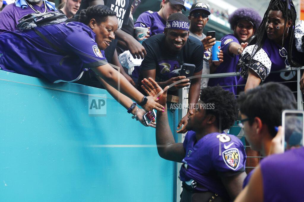 Brynn Anderson Fans greet Baltimore Ravens quarterback Lamar Jackson (8) as he exits the stadium after an NFL football game, Sunday, Sept. 8, 2019, in Miami Gardens, Fla. The Ravens defeated the Dolphins 59-10. (AP Photo/Brynn Anderson)