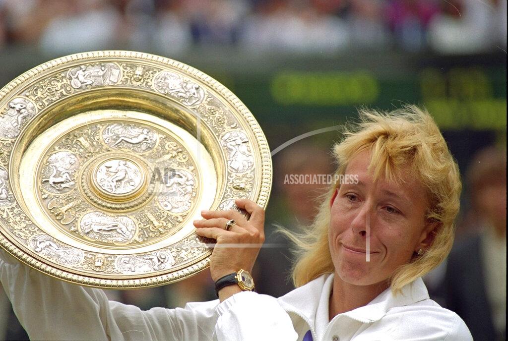 Roy Letkey FILE - In this July 7, 1990, file photo, Martina Navratilova fights back tears as she poses with her record ninth ladies singles championship trophy at Wimbledon, after defeating Zina Garrison 6-4, 6-1. (AP Photo/Roy Letkey, FIle)