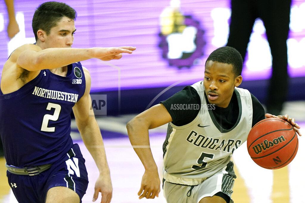 Nam Y. Huh Chicago State guard Xavier Johnson, right, drives against Northwestern guard Ryan Greer during the first half of an NCAA college basketball game in Evanston, Ill., Saturday, Dec. 5, 2020. (AP Photo/Nam Y. Huh)