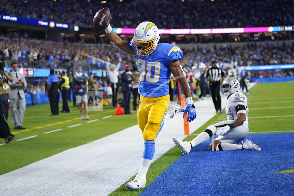 Marcio Jose Sanchez Los Angeles Chargers running back Austin Ekeler scores a touchdown as Las Vegas Raiders outside linebacker K.J. Wright defends during the first half of an NFL football game Monday, Oct. 4, 2021, in Inglewood, Calif. (AP Photo/Marcio Jose Sanchez)