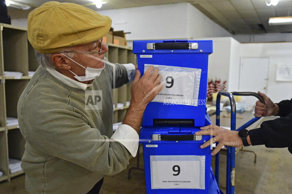 David Dermer Board of Elections worker Mike Dorio moves a box of ballots at the Trumbull County Board of Elections, Tuesday, Nov. 3, 2020, in Warren, Ohio. (AP Photo/David Dermer)