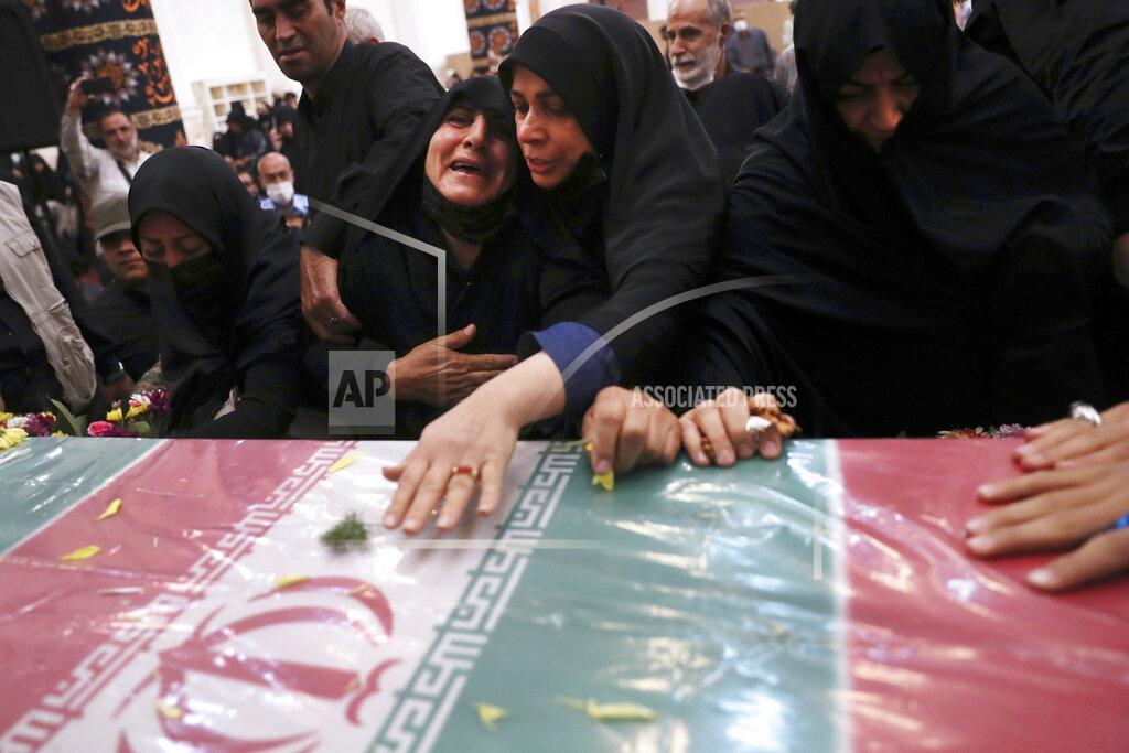 Vahid Salemi Relatives mourn over the flag draped coffin of Iran's Revolutionary Guard Col. Hassan Sayyad Khodaei during his funeral ceremony in Tehran, Iran, Tuesday, May 24, 2022. Iran's hard-line President Ebrahim Raisi vowed revenge on Monday over the killing of Sayyad Khodaei who was shot at his car by two assailants outside his home in Tehran, a still-mysterious attack on the country's powerful paramilitary force. (AP Photo/Vahid Salemi)