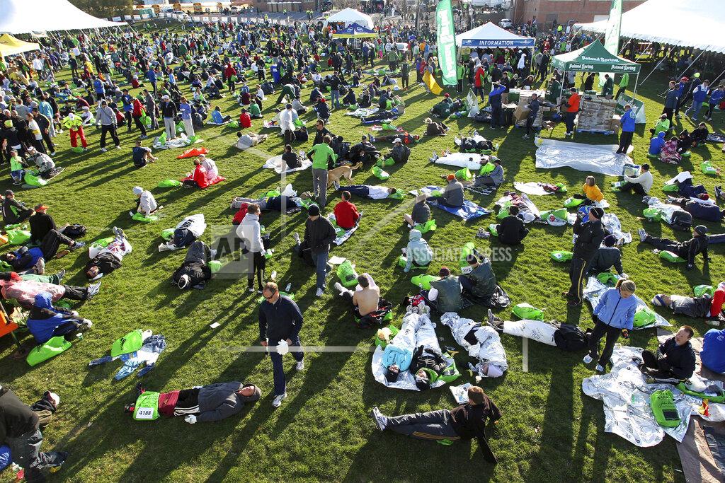 FILE - In this April 18, 2011, file photo, runners gather at the athletes village prior to the 115th running of the Boston Marathon in Hopkinton, Mass. Organizers of the marathon, postponed indefinitely because of the coronavirus pandemic, have launched a virtual Athletes' Village in 2020 to reproduce at least some of the camaraderie of the real thing. (AP Photo/Stew Milne, File)