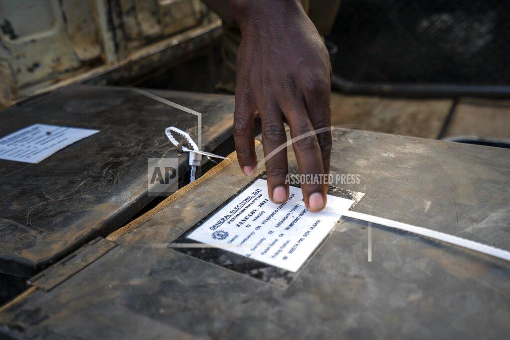 Jerome Delay A police officer checks voting material at a polling station in Kampala, Uganda, Thursday, Jan. 14, 2021. Ugandans are voting in a presidential election tainted by widespread violence that some fear could escalate as security forces try to stop supporters of leading opposition challenger BobiWine from monitoring polling stations.(AP Photo/Jerome Delay)