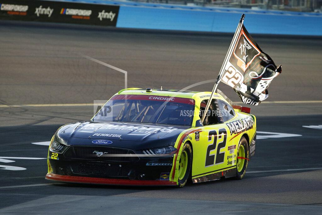 Ralph Freso Austin Cindric holds a season champion banner out the window of his race car after winning the NASCAR Xfinity Series auto race at Phoenix Raceway, Saturday, Nov. 7, 2020, in Avondale, Ariz. (AP Photo/Ralph Freso)