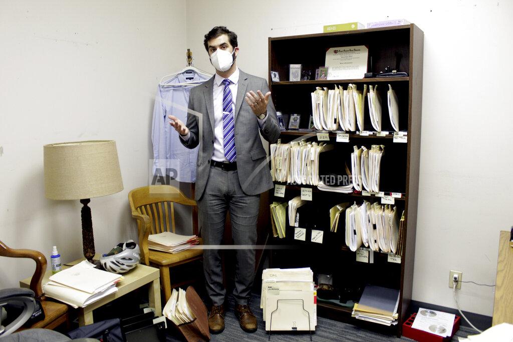 Gillian Flaccus FILE - Public defender Drew Flood with the nonprofit law firm Metropolitan Public Defender looks his files for the criminal cases he is currently working on in Portland, Ore., on May 5, 2022. (AP Photo/Gillian Flaccus, File)
