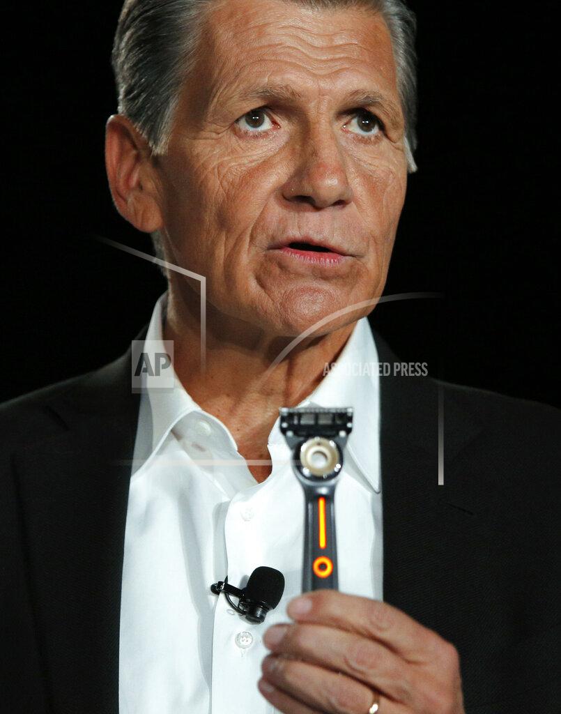 FILE - Procter & Gamble Chief Brand Officer Marc Pritchard holds up the Gillette Heated Razor during a Procter & Gamble news conference, Sunday, Jan. 5, 2020, in Las Vegas. Procter & Gamble's sales were up last year, since it happens to make just about everything people needed while staying at home: Charmin toilet paper, Bounty paper towels and Tide laundry detergent. While Gillette razors sales have slumped Pritchard has talked about people's shaving habits and how P&G is creating products for consumers who are home more. (AP Photo/John Locher, file)