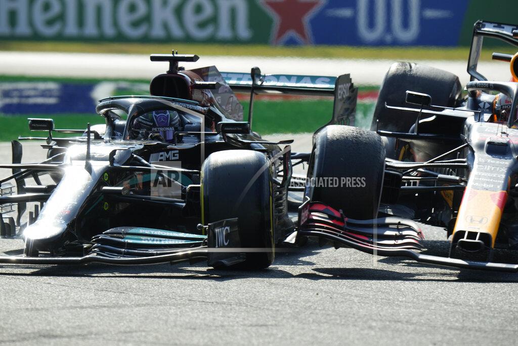 Luca Bruno Mercedes driver Lewis Hamilton of Britain crashes with Red Bull driver Max Verstappen of the Netherlands during the Italian Formula One Grand Prix, at Monza racetrack, in Monza, Italy, Sunday, Sept.12, 2021. (AP Photo/Luca Bruno)