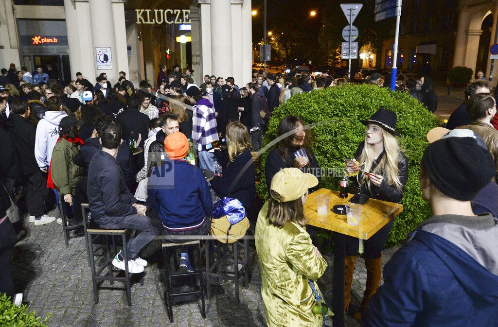 Czarek Sokolowski People gather and celebrate as bars, clubs and other establishments reopened in Poland after being closed for seven months, in Warsaw, Poland, Friday, May 14, 2021. (AP Photo/Czarek Sokolowski)