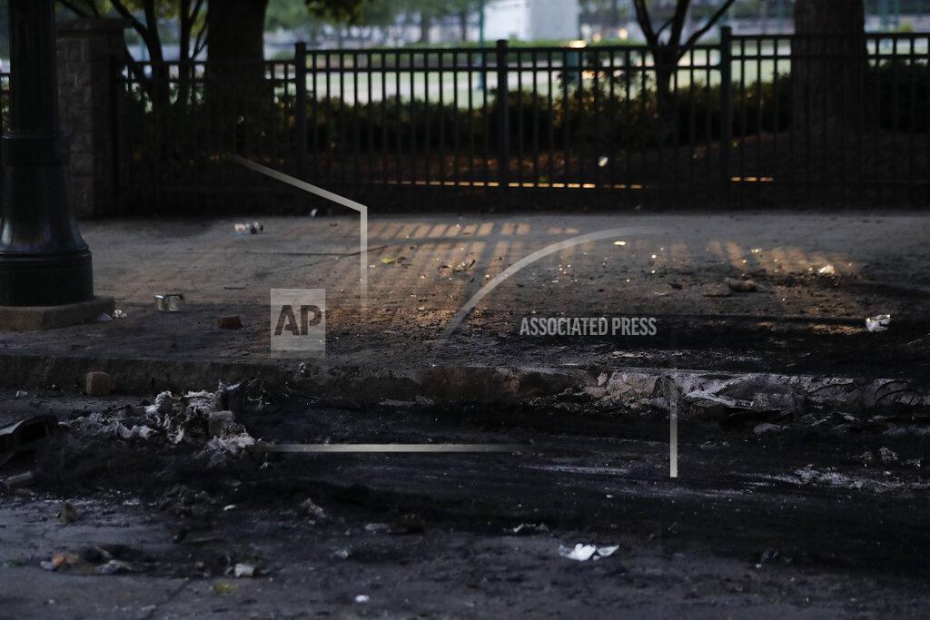 Brynn Anderson The remains of a car fire are seen in the aftermath of a demonstration against police violence on Saturday, May 30, 2020, in Atlanta. (AP Photo/Brynn Anderson)