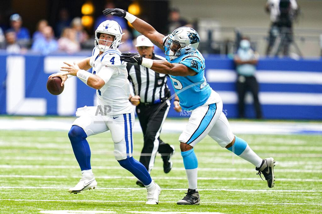 Michael Conroy Carolina Panthers defensive end Kendall Donnerson (76) chases Indianapolis Colts quarterback Sam Ehlinger (4) during the second half of an NFL exhibition football game in Indianapolis, Sunday, Aug. 15, 2021. (AP Photo/Michael Conroy)