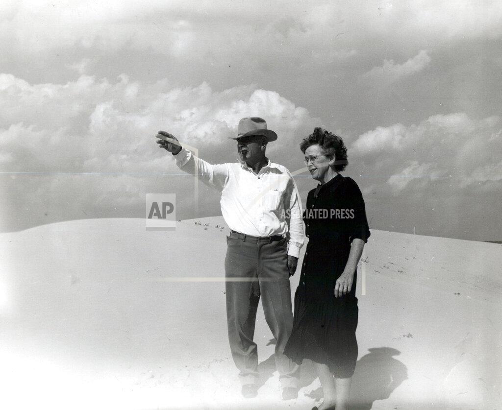 Uncredited This undated family photo provided by Ashley Williams Watt shows Watt's great-grandfather, Glen Joseph Allen, and his wife, Helen, surveying land in West Texas. Allen was a cow buyer in Fort Worth and eventually moved to sandy terrain in the Permian Basin to raise cattle. His great-granddaughter, Ashley Williams Watt, is carrying on in their tradition — but worries that pollution from abandoned oil wells on some of her land may threaten the legacy. "What if that history ends with me?" Watt says. (Watt Family via AP)