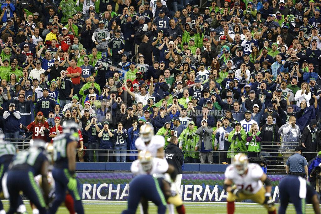 Elaine Thompson FILE - In this Sunday, Sept. 15, 2013, file photo, Seattle Seahawks fans yell during a San Francisco 49ers possession in the first half of an NFL football game in Seattle. Fans were attempting to set a Guinness World Record for fan noise. One of the best homefield advantages in the NFL will sit empty on Sunday night, Sept. 20, 2020. . The Seattle Seahawks know it will be strange having no fans inside CenturyLink Field. But being an opponent in Seattle has gained such a reputation even some Patriots are disappointed there won't be fans. (AP Photo/Elaine Thompson, File)
