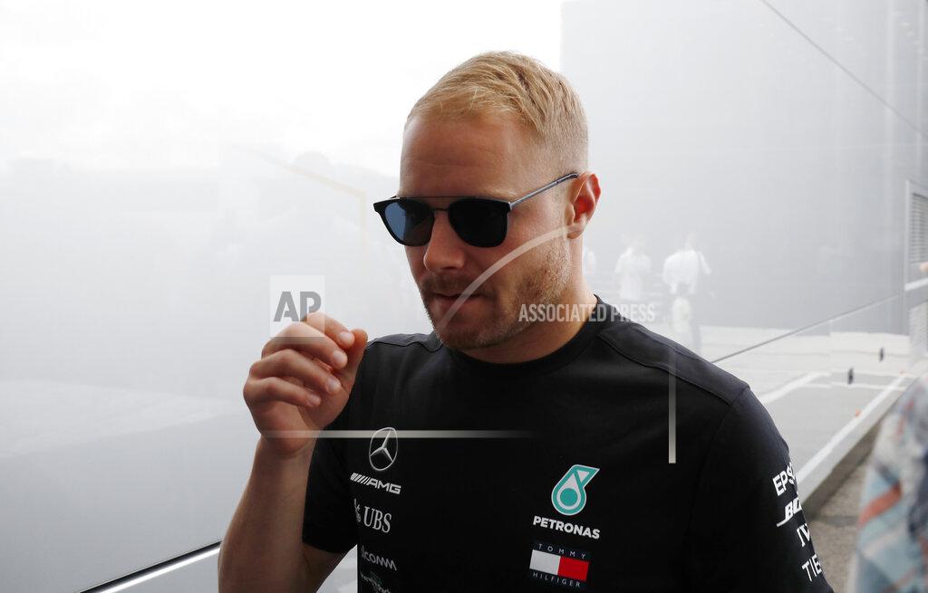 Laszlo Balogh Mercedes driver Valtteri Bottas of Finland walks prior to the start of the Hungarian Formula One Grand Prix at the Hungaroring racetrack in Mogyorod, northeast of Budapest, Hungary, Sunday, Aug. 4, 2019. (AP Photo/Laszlo Balogh)