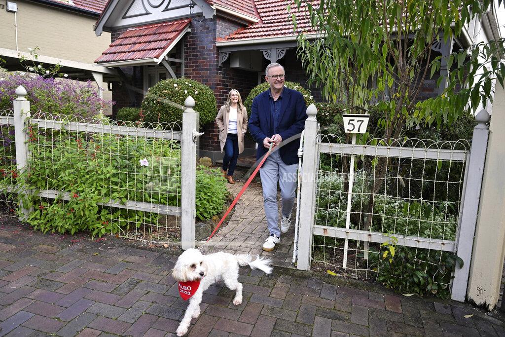 Dean Lewins Australia's Prime Minister-elect Anthony Albanese, right, and his partner Jodie Haydon go for a walk with their dog, Toto, in Sydney, Sunday, May 22, 2022. Albanese has promised to rehabilitate Australia's international reputation as a climate change laggard with steeper cuts to greenhouse gas emissions. (Dean Lewins/AAP Image via AP)