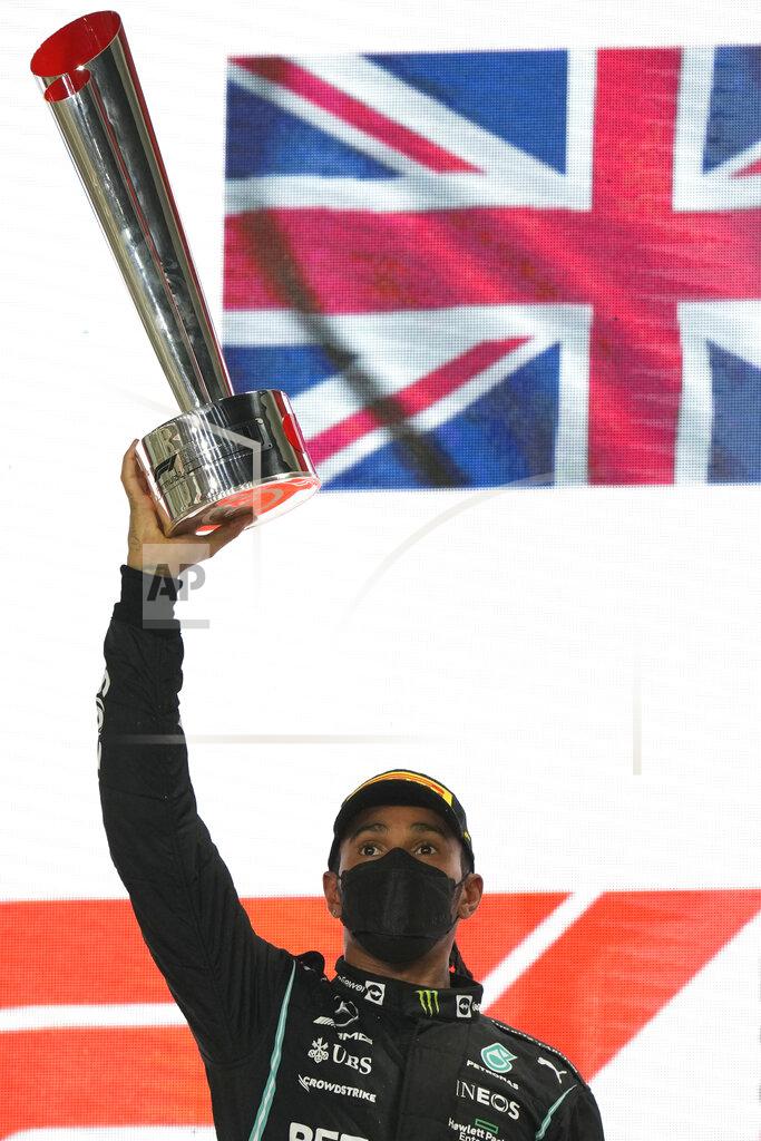 Darko Bandic Mercedes driver Lewis Hamilton of Britain celebrates his victory after the Qatar Formula One Grand Prix at the Lusail International Circuit in Lusail, Qatar, Sunday, Nov. 21, 2021. (AP Photo/Darko Bandic)