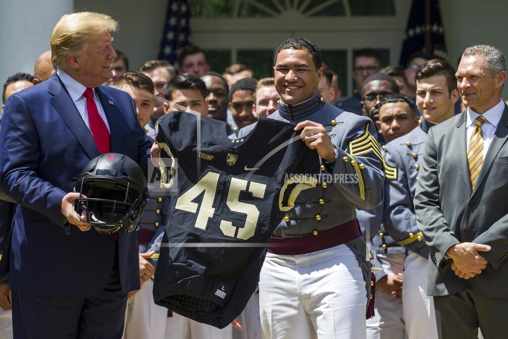 Alex Brandon President Donald Trump accepts a jersey from Army running back Darnell Woolfolke Army during the presentation of the Commander-in-Chief's Trophy to the U.S. Military Academy at West Point football team in the Rose Garden of the White House, Monday, May 6, 2019, in Washington. (AP Photo/Alex Brandon)