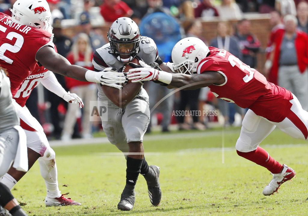 Rogelio V. Solis Mississippi State running back Dontavian Lee (28) runs between two Arkansas defenders during the second half of an NCAA college football game in Starkville, Miss., Saturday, Nov. 17, 2018. Mississippi State won 52-6. (AP Photo/Rogelio V. Solis)