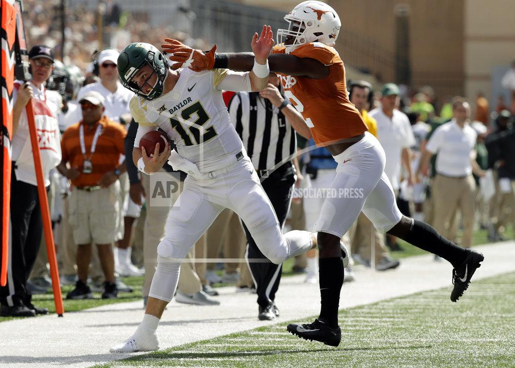 Eric Gay Baylor quarterback Charlie Brewer (12) is hit by Texas defensive back Kris Boyd (2) as he runs during the first half of an NCAA college football game, Saturday, Oct. 13, 2018, in Austin, Texas. (AP Photo/Eric Gay)