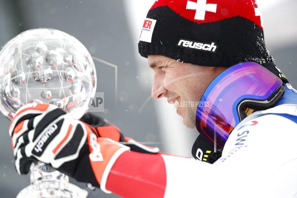 Gabriele Facciotti Switzerland's Beat Feuz holds the trophy of the alpine ski, men's World Cup downhill, in Lenzerheide, Switzerland, Wednesday, March 17, 2021. (AP Photo/Gabriele Facciotti)