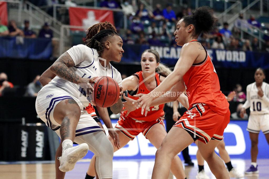Michael Wyke Stephen F. Austin guard Zya Nugent, left, looks for a way around Sam Houston State forward Kaylee Jefferson (13) and forward Madelyn Batista, right, during the first half of an NCAA college basketball game for the Southland Conference women's tournament championship Sunday, March 14, 2021, in Katy, Texas. (AP Photo/Michael Wyke)