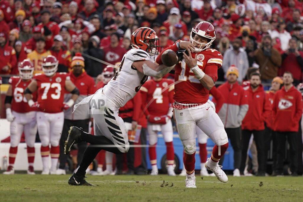 Charlie Riedel Kansas City Chiefs quarterback Patrick Mahomes (15) fumbles as he is tackled by Cincinnati Bengals defensive end Sam Hubbard, left, during overtime in the AFC championship NFL football game, Sunday, Jan. 30, 2022, in Kansas City, Mo. The Bengals won 27-24. (AP Photo/Charlie Riedel)