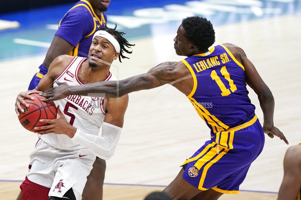 Mark Humphrey Arkansas' Moses Moody (5) drives against LSU's Josh LeBlanc Sr. (11) in the second half of an NCAA college basketball game in the Southeastern Conference Tournament Saturday, March 13, 2021, in Nashville, Tenn. (AP Photo/Mark Humphrey)