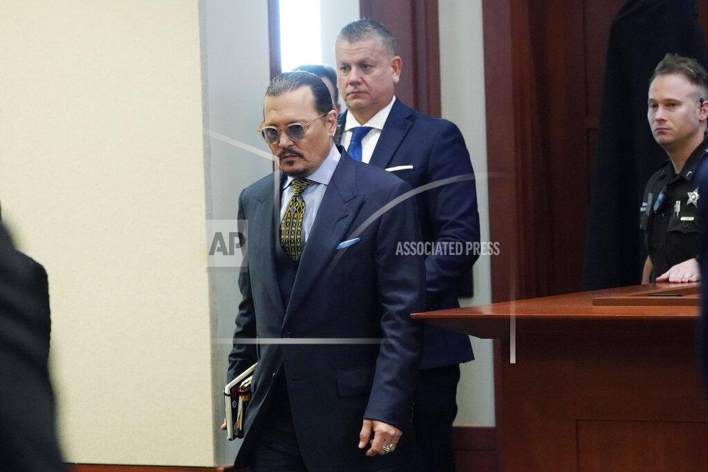 Steve Helber Actor Johnny Depp walks into the courtroom after a break at the Fairfax County Circuit Courthouse in Fairfax, Va., Monday, May 23, 2022. Depp sued his ex-wife Amber Heard for libel in Fairfax County Circuit Court after she wrote an op-ed piece in The Washington Post in 2018 referring to herself as a "public figure representing domestic abuse." (AP Photo/Steve Helber, Pool)