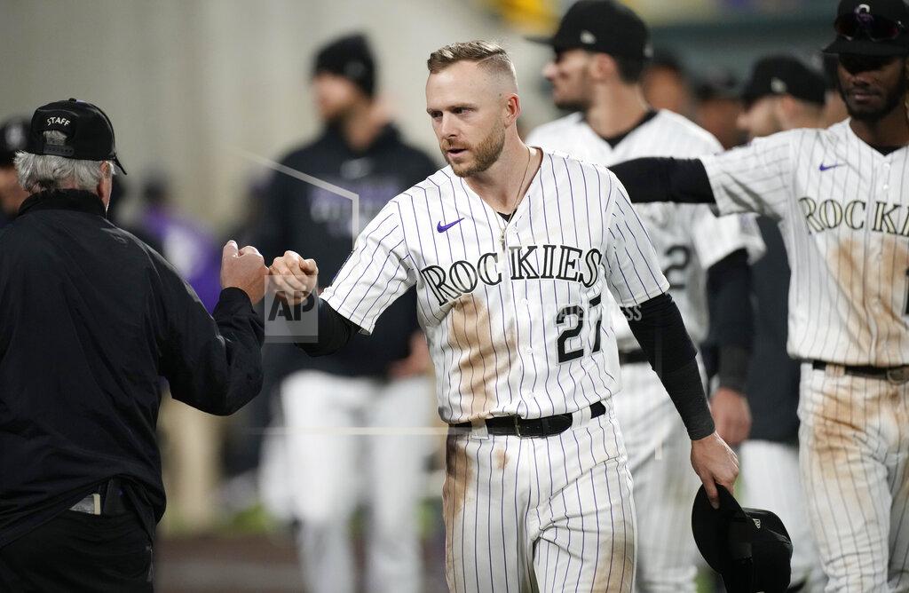 David Zalubowski Colorado Rockies shortstop Trevor Story greets a field security guard during a ceremonial walk around the park after a baseball game Wednesday, Sept. 29, 2021, in Denver. The Rockies posted a 10-5 victory over the Washington Nationals. (AP Photo/David Zalubowski)