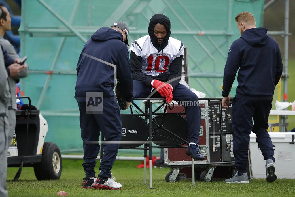 Matt Dunham Houston Texans' wide receiver DeAndre Hopkins, 10, sits on a table during an NFL practice session at the London Irish rugby team training ground in the Sunbury-on-Thames suburb of south west London, Friday, Nov. 1, 2019. The Houston Texans are preparing for an NFL regular season game against the Jacksonville Jaguars in London on Sunday. (AP Photo/Matt Dunham)