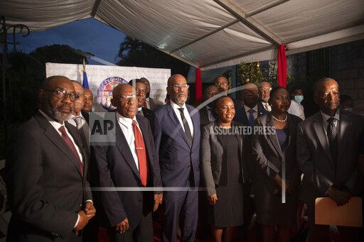 Haiti's Prime Minister Ariel Henry, center, poses for a group photo with the new members of his cabinet, in Port-au-Prince, Haiti, Wednesday, Nov. 24, 2021. (AP Photo/Odelyn Joseph)