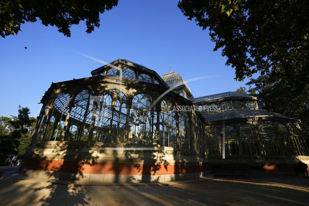 Paul White The Glass Palace stands shaded by trees in the Retiro park in Madrid, Spain, Thursday, July 22, 2021. Madrid's tree-lined Paseo del Prado boulevard and the adjoining Retiro park have been added to UNESCO's World Heritage list. The UNESCO World Heritage Committee backed the candidacy that highlighted the green area's introduction of nature into Spain's capital. (AP Photo/Paul White)