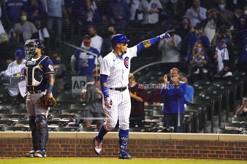 David Banks Chicago Cubs' Javier Baez gestures as he crosses home plate after hitting a home run against the Milwaukee Brewers during the fourth inning of a baseball game, Monday, April 5, 2021, in Chicago. (AP Photo/David Banks)