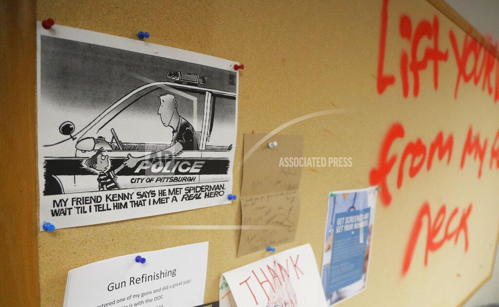 Julio Cortez A bulletin board is sprayed with graffiti inside the Minneapolis police 3rd Precinct on Thursday, May 28, 2020, in Minneapolis. Protests over the death of George Floyd, a black man who died in police custody Monday, broke out in Minneapolis for a third straight night. (AP Photo/Julio Cortez)