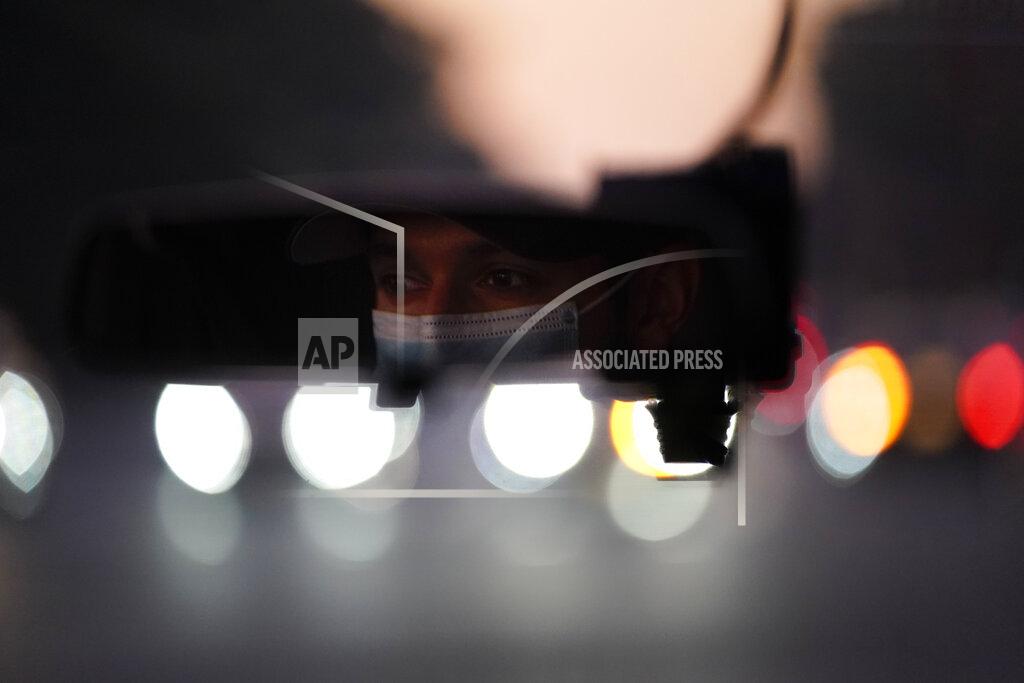 Jae C. Hong Emergency medical technician Joshua Hammond, 25, of Emergency Ambulance Service, drives an ambulance to his station in Placentia, Calif. Friday, Jan. 8, 2021. (AP Photo/Jae C. Hong)