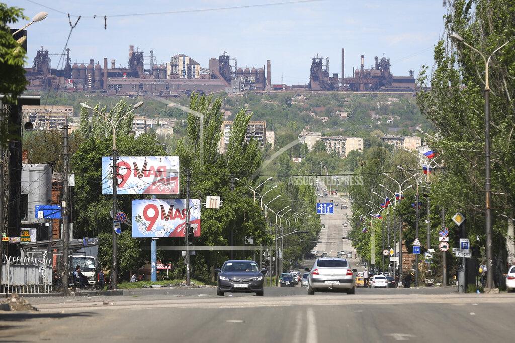 Alexei Alexandrov A view of a street in Mariupol, in territory under the government of the Donetsk People's Republic, eastern Ukraine, Tuesday, May 17, 2022, with the Azovstal steel plant in the background. (AP Photo/Alexei Alexandrov)