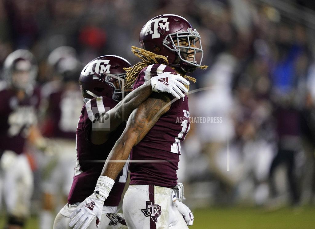 David J. Phillip Texas A&M wide receiver Kendrick Rogers, right, celebrates with Camron Buckley (14) after catching a pass for a two-point conversion during the seventh overtime of an NCAA college football game against LSU Saturday, Nov. 24, 2018, in College Station, Texas. Texas A&M won 74-72. (AP Photo/David J. Phillip)