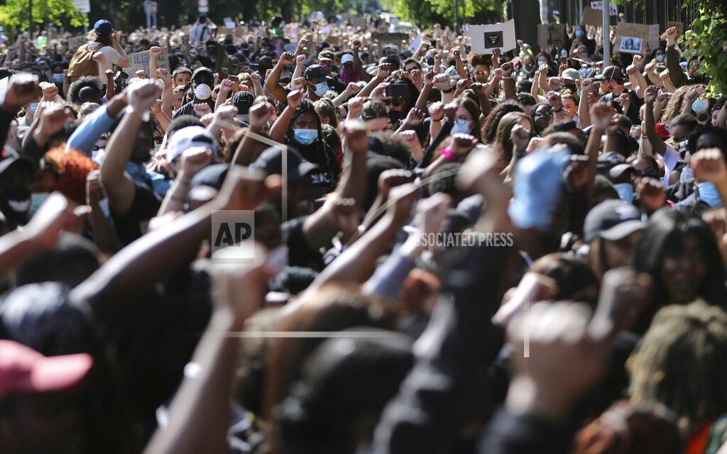 Niall Carson People protest under the slogan Black Lives Matter and I Can't Breathe, as they rally outside the US Embassy in Dublin, Ireland, Monday June 1, 2020, following the recent death of George Floyd in Minneapolis, USA. Floyd died after a US officer pressed his knee into his neck for several minutes even after he stopped moving and pleading for air. (Niall Carson / PA via AP)