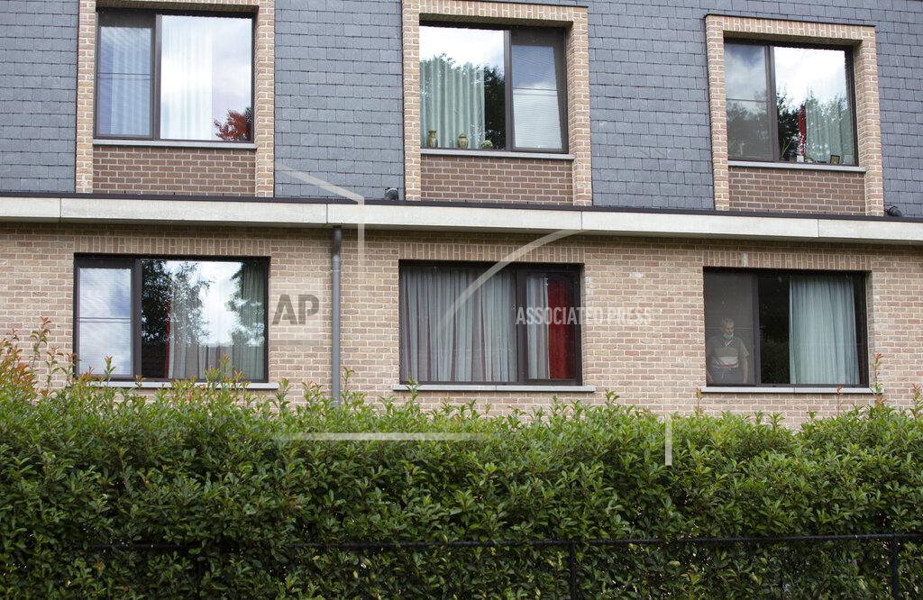 Virginia Mayo A resident in the window of a nursing home speaks with his relative from the window of his room at the Molenheide elderly care home in Wijnegem, Belgium on Tuesday, Aug. 18, 2020.Authorities in Belgium fear another deadly wave of coronavirus cases could soon hit care homes as the country confronts the risk of seeing its hospitals overwhelmed by COVID-19 patients, leading them to restrict nursing home visits. (AP Photo/Virginia Mayo)