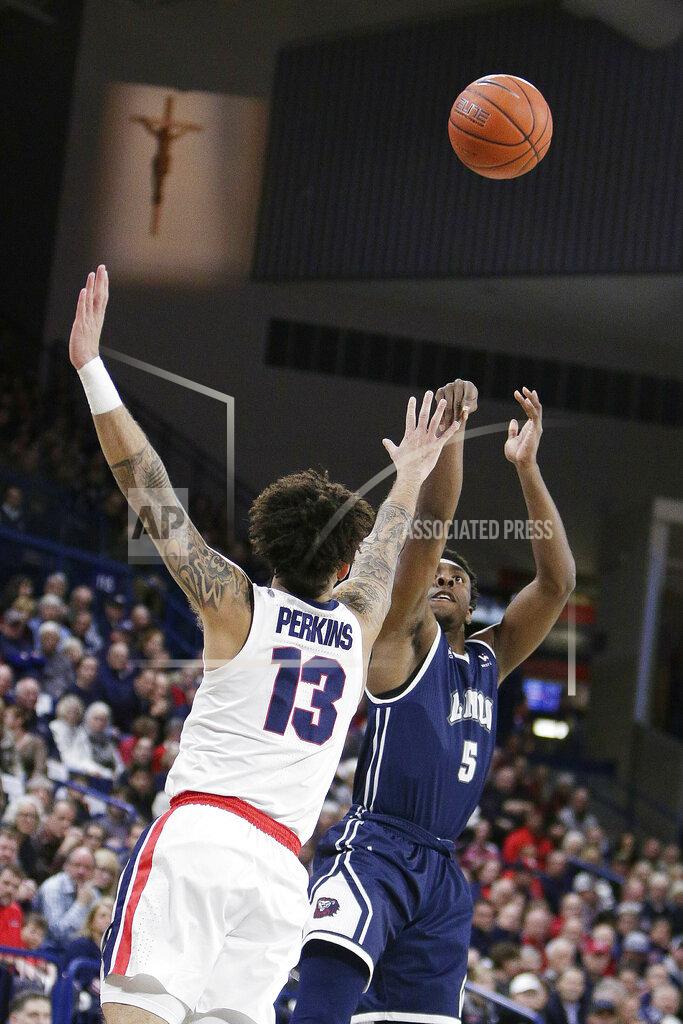 Young Kwak Loyola Marymount guard James Batemon (5) shoots while defended by Gonzaga guard Josh Perkins (13) during the first half of an NCAA college basketball game in Spokane, Wash., Thursday, Jan. 17, 2019. (AP Photo/Young Kwak)