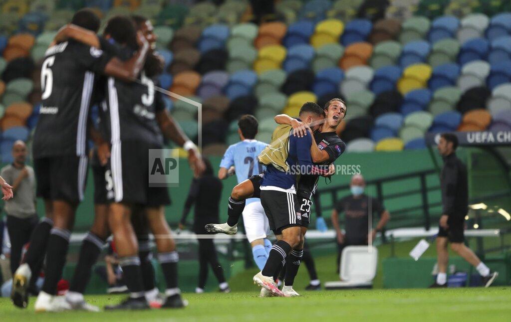 Miguel A. Lopes Lyon players celebrate at the end of the Champions League quarterfinal soccer match between Lyon and Manchester City at the Jose Alvalade stadium in Lisbon, Portugal, Saturday, Aug. 15, 2020. Lyon won the match 3-1. (Miguel A. Lopes/Pool via AP)