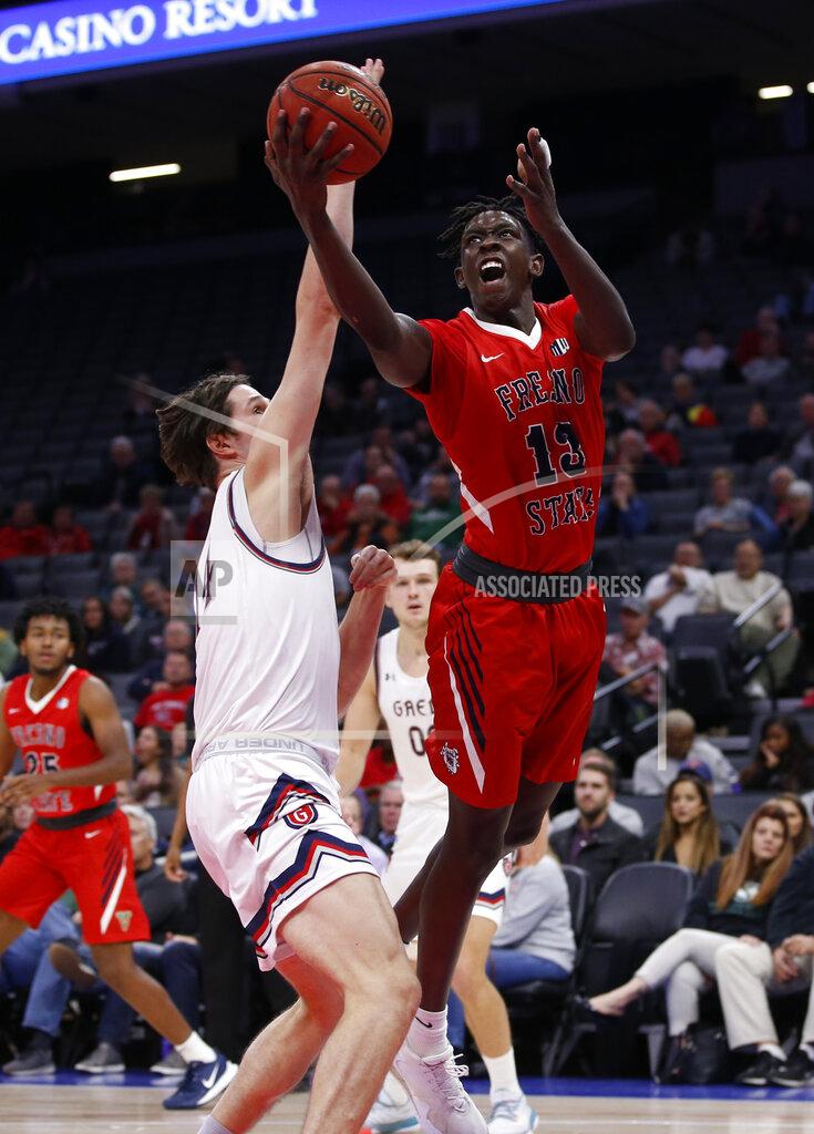 Rich Pedroncelli Fresno State guard Aguir Agau, right, goes to the basket against Saint Mary's forward Kyle Bowen during the second half of an NCAA college basketball game in Sacramento, Calif., Wednesday, Nov. 20, 2019. Saint Mary's won 68-58. (AP Photo/Rich Pedroncelli)
